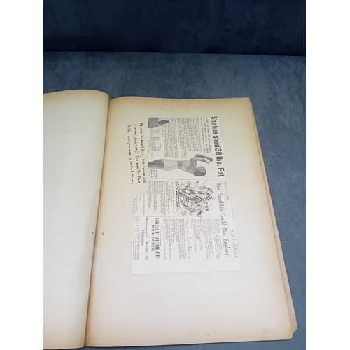 513 - A vintage, orange, spiral-bound scrapbook featuring a stylized 