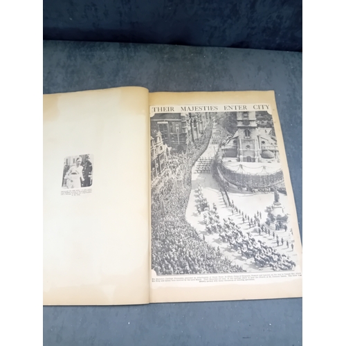 513 - A vintage, orange, spiral-bound scrapbook featuring a stylized 