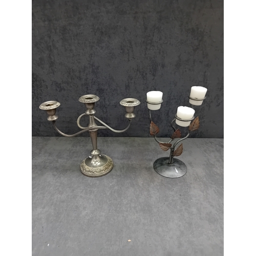 444 - A group of two candelabras. The first is a traditional style Ianthe silver-plated three-light candel... 