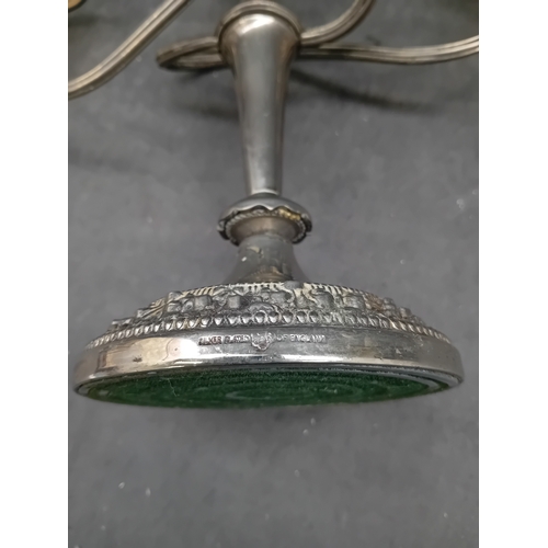 444 - A group of two candelabras. The first is a traditional style Ianthe silver-plated three-light candel... 