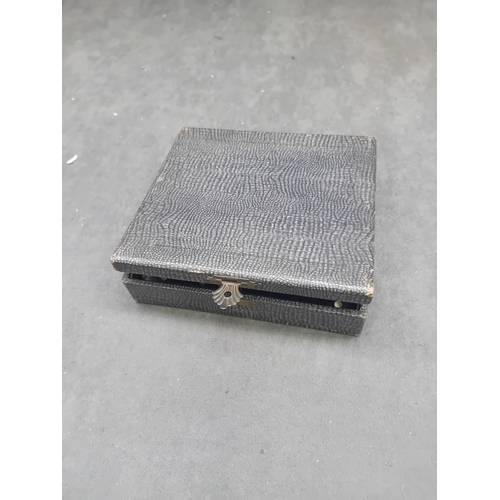 456 - A vintage cased set of red Bakelite and Catalin dominoes. The set features individual two-tone piece... 