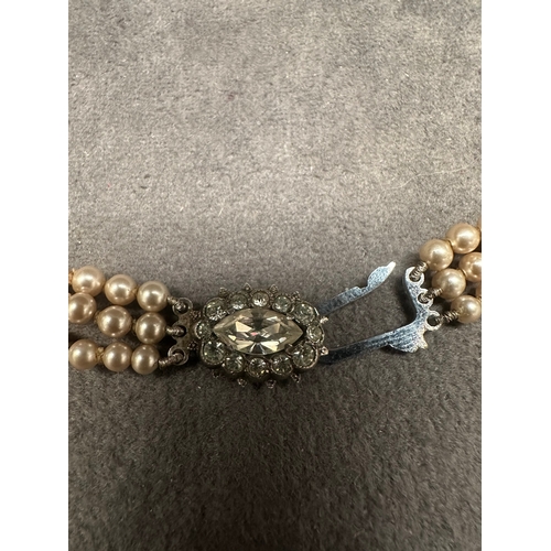 471 - A vintage three-strand necklace, exhibiting a classic style. It is composed of consistent-sized, lig... 