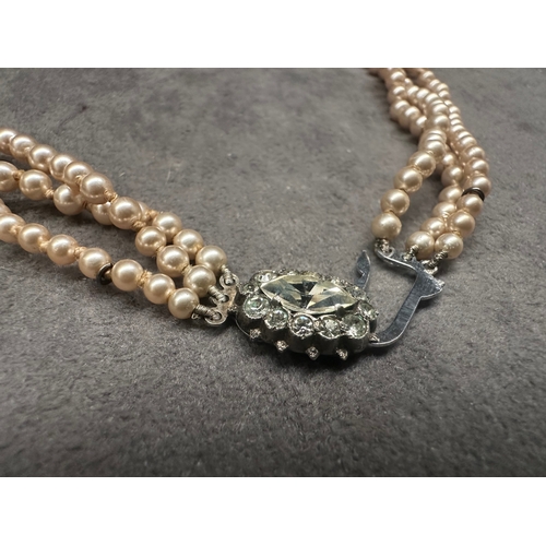 471 - A vintage three-strand necklace, exhibiting a classic style. It is composed of consistent-sized, lig... 