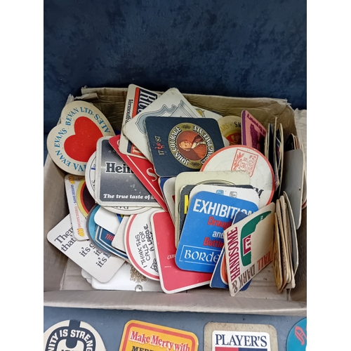486 - A collection of vintage paperboard beverage coasters or beer mats, dating from the mid-to-late 20th ... 