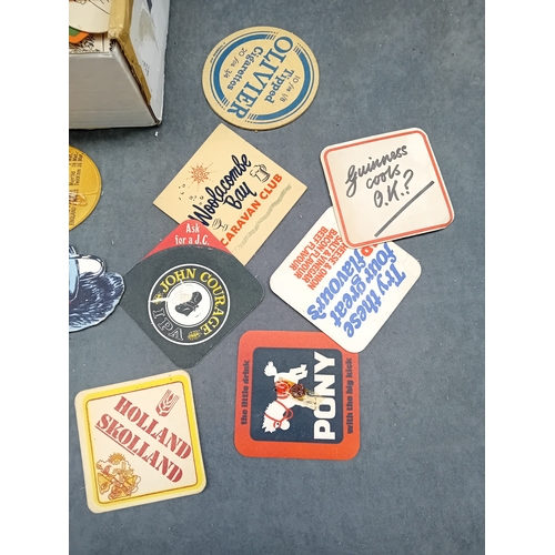 501 - A collection of approximately 50 vintage German beer coasters, primarily crafted from pulpboard or t... 