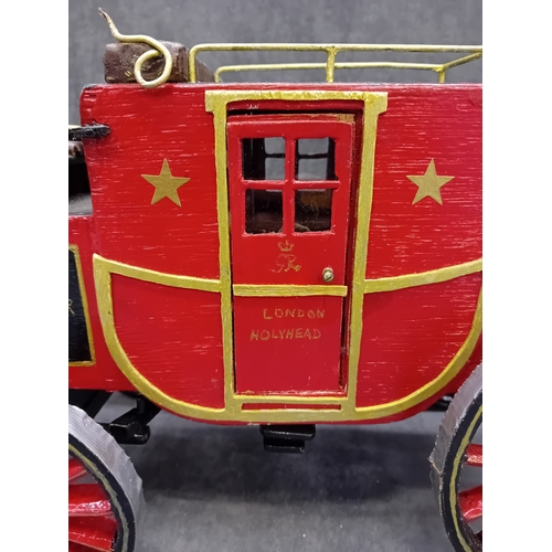 567 - A Wells Fargo & Co Overland Stage Coach designed as a painted wooden of a 19th-century style sta... 