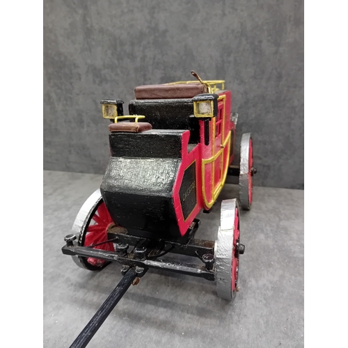567 - A Wells Fargo & Co Overland Stage Coach designed as a painted wooden of a 19th-century style sta... 