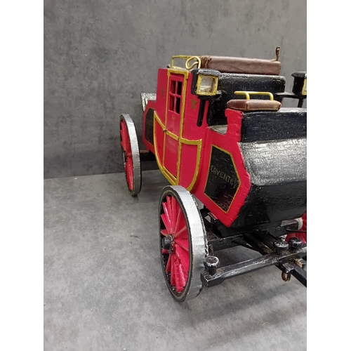 567 - A Wells Fargo & Co Overland Stage Coach designed as a painted wooden of a 19th-century style sta... 