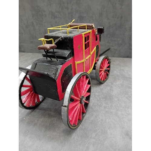 567 - A Wells Fargo & Co Overland Stage Coach designed as a painted wooden of a 19th-century style sta... 