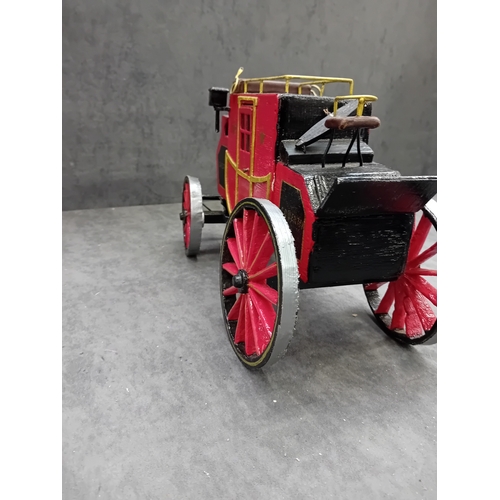 567 - A Wells Fargo & Co Overland Stage Coach designed as a painted wooden of a 19th-century style sta... 