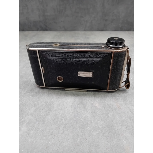 110 - This lot comprises a vintage J. H. L. Motor Dresden folding camera and an unbranded brown leather ca... 