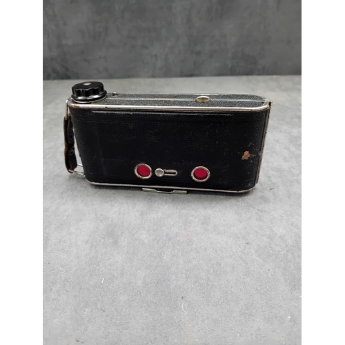 110 - This lot comprises a vintage J. H. L. Motor Dresden folding camera and an unbranded brown leather ca... 