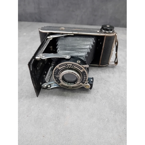 110 - This lot comprises a vintage J. H. L. Motor Dresden folding camera and an unbranded brown leather ca... 