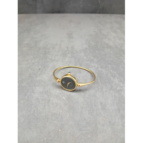 120 - A Maurice Lacroix ladies' quartz bangle watch, crafted from yellow-toned metal. It features a minima... 