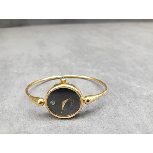 120 - A Maurice Lacroix ladies' quartz bangle watch, crafted from yellow-toned metal. It features a minima... 