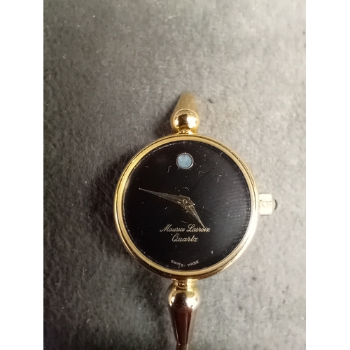 120 - A Maurice Lacroix ladies' quartz bangle watch, crafted from yellow-toned metal. It features a minima... 