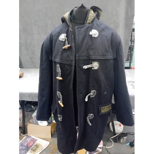 18 - A navy blue duffle coat, likely constructed from a wool or wool-blend fabric, featuring a hood with ... 