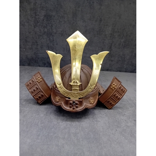 20 - A Vintage Japanese Miniature Samurai Kabuto Helmet, constructed from dark brown, heavily textured ca... 