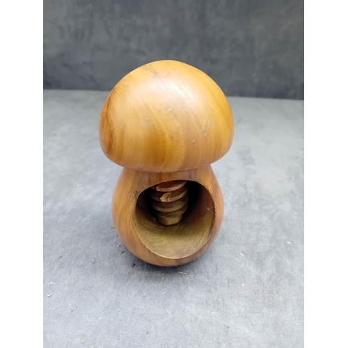 22 - A collection of eight turned wooden objects, primarily crafted in various mushroom forms, exhibiting... 