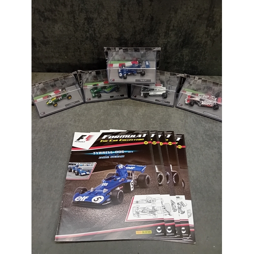 328 - A group of five die-cast Formula 1 model cars and accompanying magazines from the Panini Formula 1 T... 