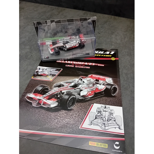 328 - A group of five die-cast Formula 1 model cars and accompanying magazines from the Panini Formula 1 T... 