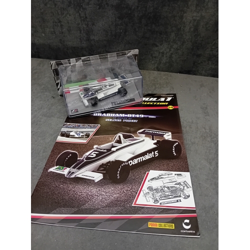 328 - A group of five die-cast Formula 1 model cars and accompanying magazines from the Panini Formula 1 T... 