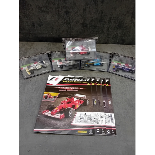 A group of five die-cast Formula 1 miniature car models from the Panini ...