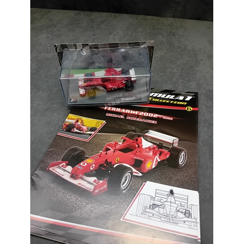 A group of five die-cast Formula 1 miniature car models from the Panini ...