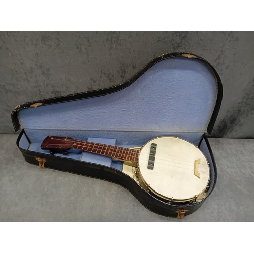 34 - A vintage four-string banjo-ukulele, or small tenor banjo, housed within its original, fitted hard-s... 