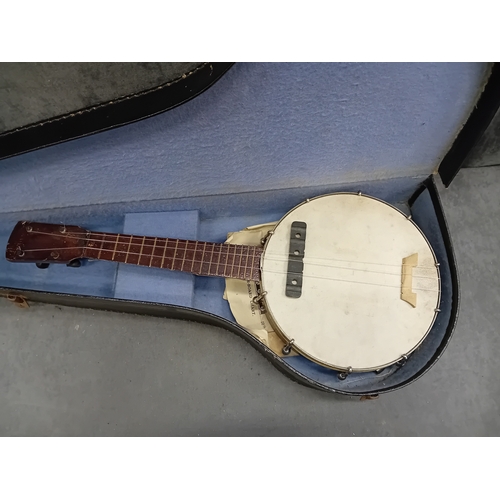 34 - A vintage four-string banjo-ukulele, or small tenor banjo, housed within its original, fitted hard-s... 