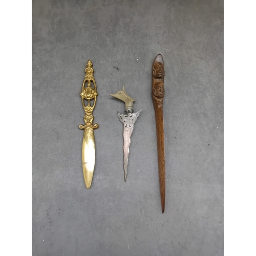 464 - A Malaysian silver Kris letter opener, exhibiting a wavy, damascened iron or steel blade, an ornate ... 