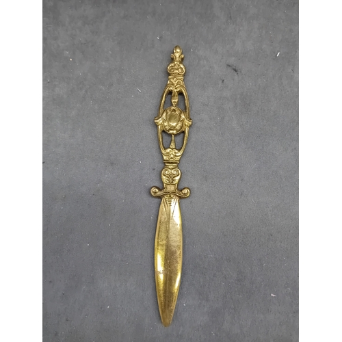 464 - A Malaysian silver Kris letter opener, exhibiting a wavy, damascened iron or steel blade, an ornate ... 