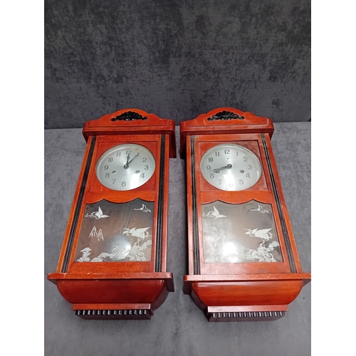 465 - A Matching pair of wall clock - Polaris Branding with oriental theme. one has minor glass damage as ... 