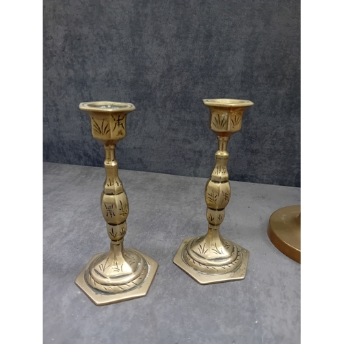 482 - This lot comprises five brass or brass-alloy candleholders/candlesticks, presenting a variety of sty... 