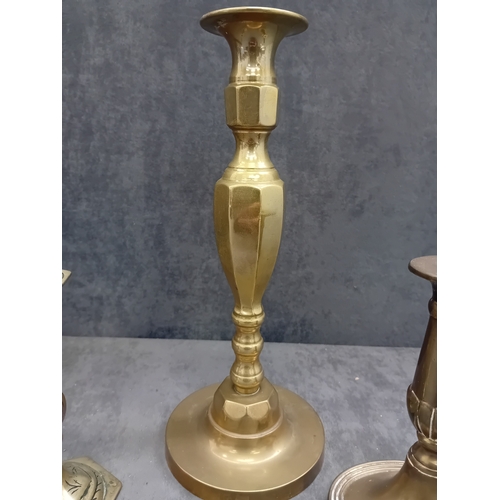 482 - This lot comprises five brass or brass-alloy candleholders/candlesticks, presenting a variety of sty... 