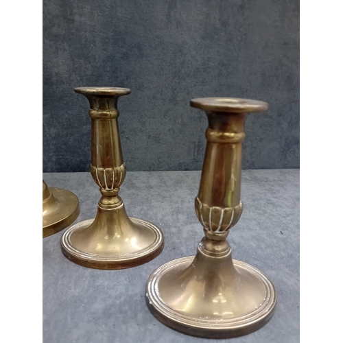 482 - This lot comprises five brass or brass-alloy candleholders/candlesticks, presenting a variety of sty... 