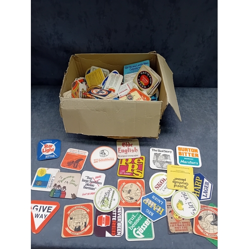 495 - A large collection of vintage beverage coasters, primarily crafted from absorbent pulpboard or cardb... 