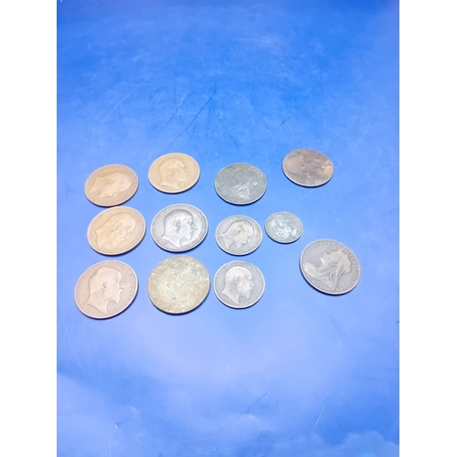 661 - A collection of 12 heavily circulated British base metal coins, primarily copper and bronze, dating ... 