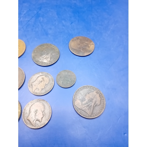 661 - A collection of 12 heavily circulated British base metal coins, primarily copper and bronze, dating ... 