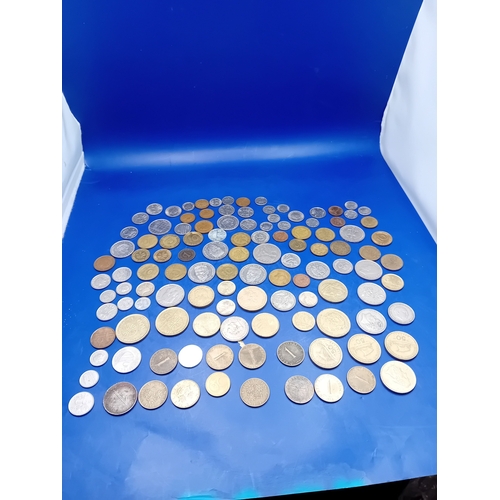 664 - A large collection of 136 assorted foreign coins from various global origins. The collection include... 