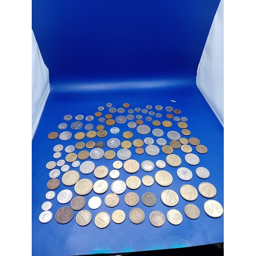 664 - A large collection of 136 assorted foreign coins from various global origins. The collection include... 