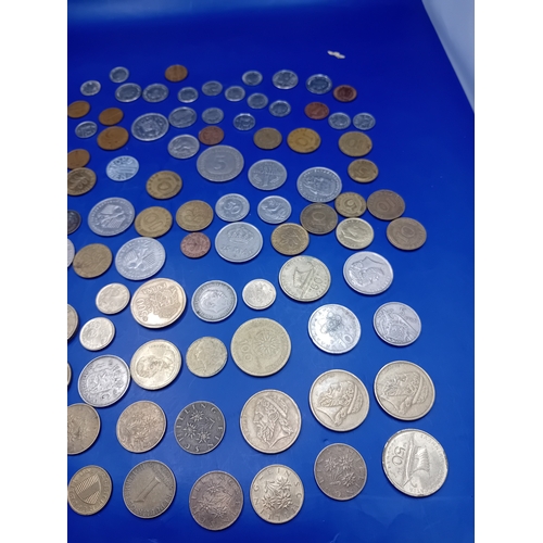 664 - A large collection of 136 assorted foreign coins from various global origins. The collection include... 