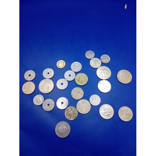 666 - A collection of 23 pieces of assorted world coinage. The lot comprises a heterogeneous mix of base m... 
