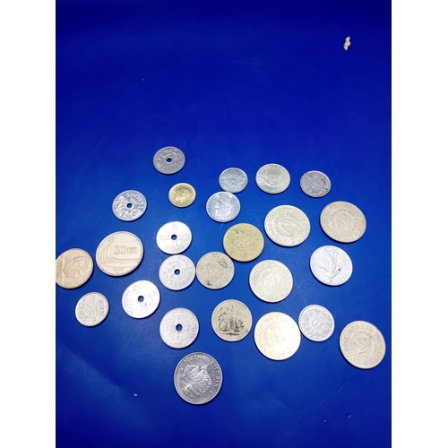 666 - A collection of 23 pieces of assorted world coinage. The lot comprises a heterogeneous mix of base m... 