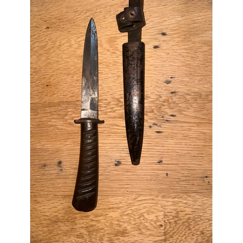 99 - This lot consists of a fixed-blade military fighting knife, identified through consensus as a World ... 