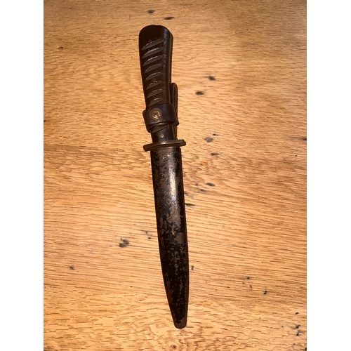 99 - This lot consists of a fixed-blade military fighting knife, identified through consensus as a World ... 