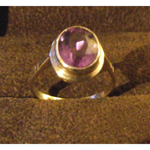 53 - Ladies 9ct gold dress ring with central faceted cabochon cut purple central stone  size P  2.7g appr... 