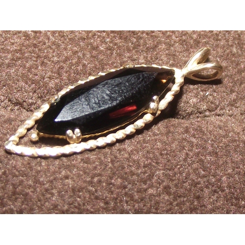 63 - Ladies 9ct gold  pendant set with faceted elongated central stone   3cm in length   2g approx.