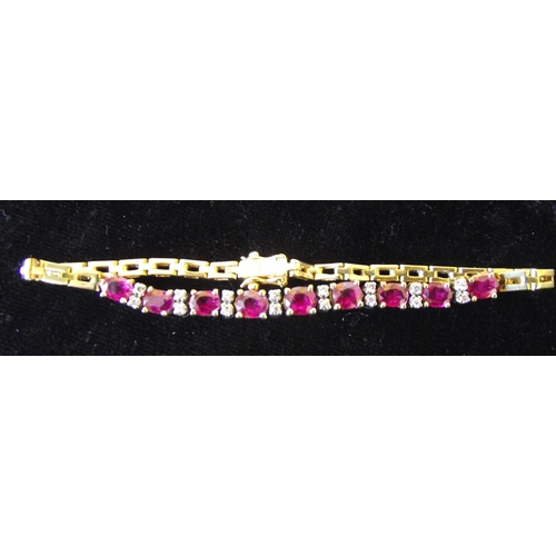 64 - Superb outstanding quality 18ct gold fully hallmarked  bracelet  consisting of  9  oval shape rubies... 