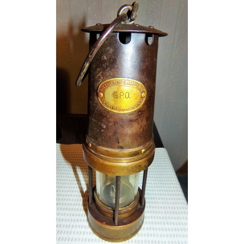 13 - A GPO marked Miners Lamp. Black painted body with brass fittings. Brass badge marked GPO Patterson l... 